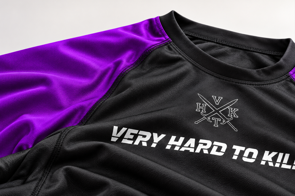 Close-up of VHTK Purple Rankings rash guard fabric and shoulder panel.