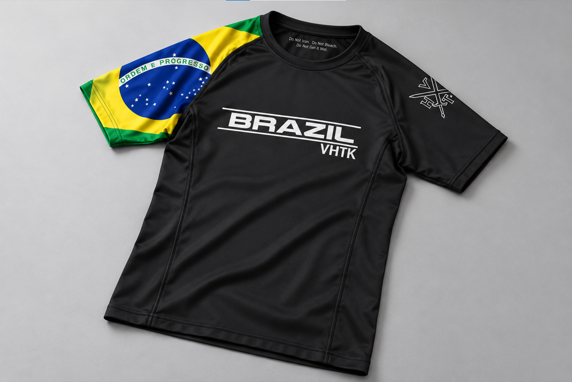 Front view of VHTK Brazil Nationals black rash guard with a Brazilian flag sleeve and white BRAZIL chest lettering.