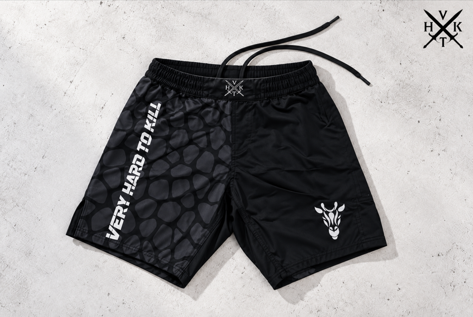 VHTK Giraffe 2.0 Black grappling shorts showing the elastic waistband, extended internal drawstring and charcoal giraffe artwork.