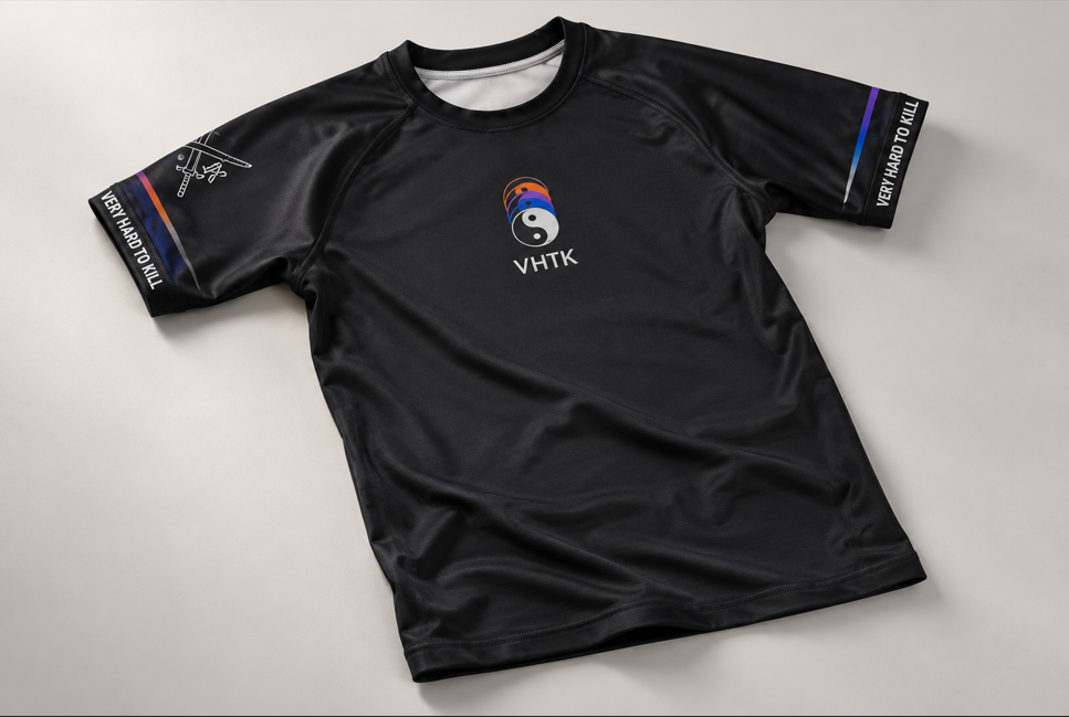 VHTK Yin Yang Black short sleeve rash guard with multicolored chest artwork and branded sleeve cuffs on a light gray background.